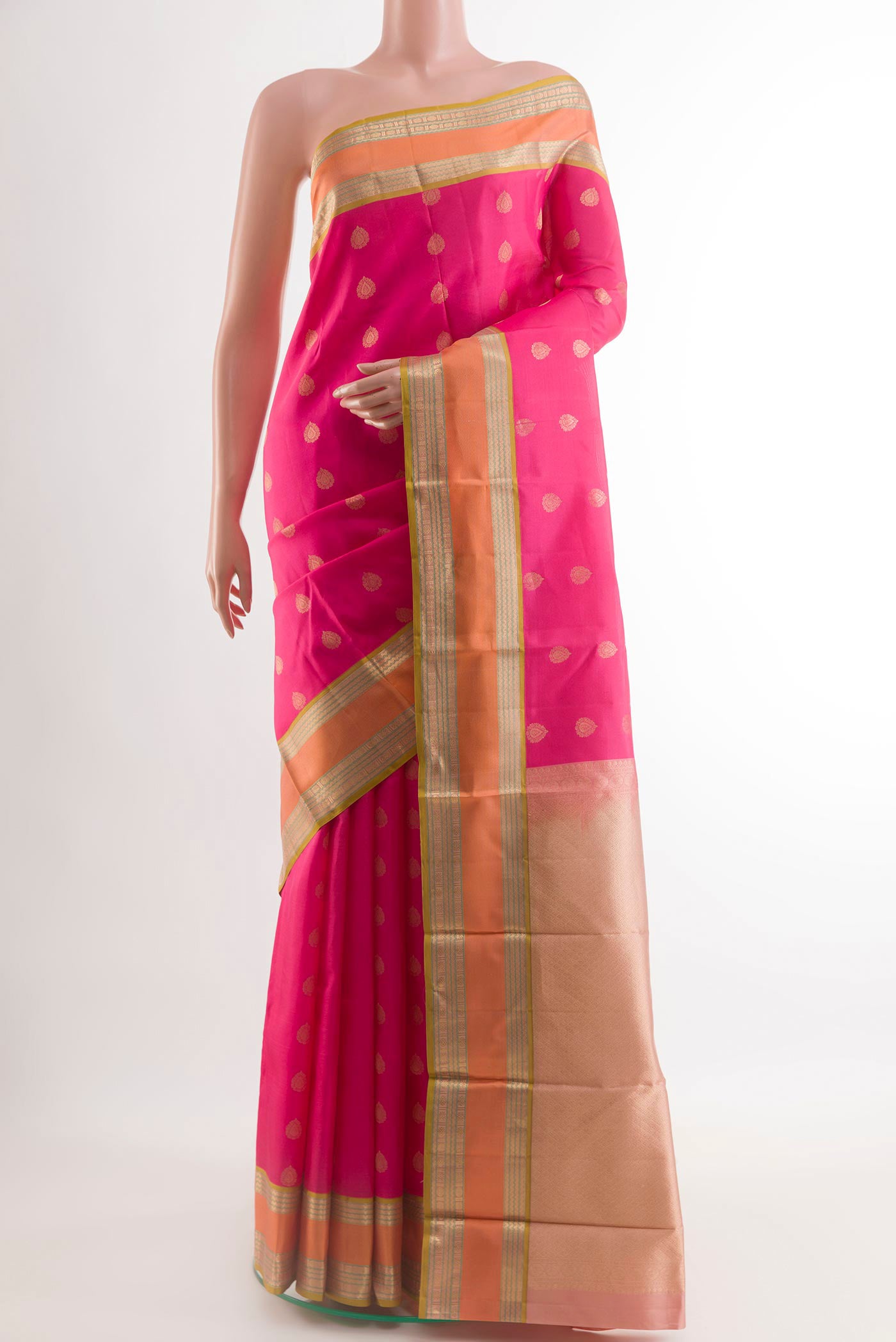 Pink Kanjivaram Silk Saree with Zari Butta on the body and Zari Border.  displayed on a mannequin