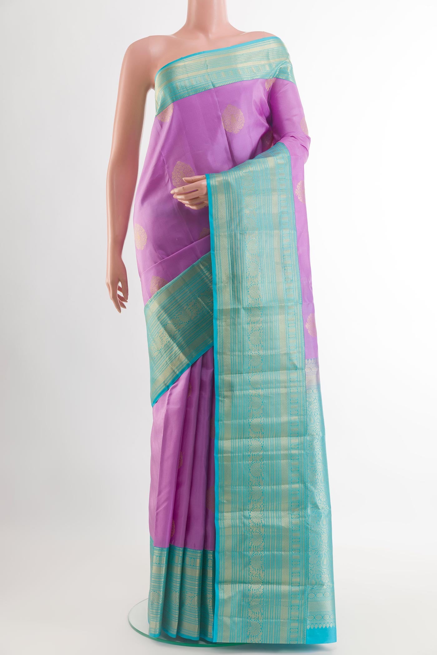 Lavender Kanchipuram Silk Saree with Zari Butta on the body and Zari Border.  displayed on a mannequin