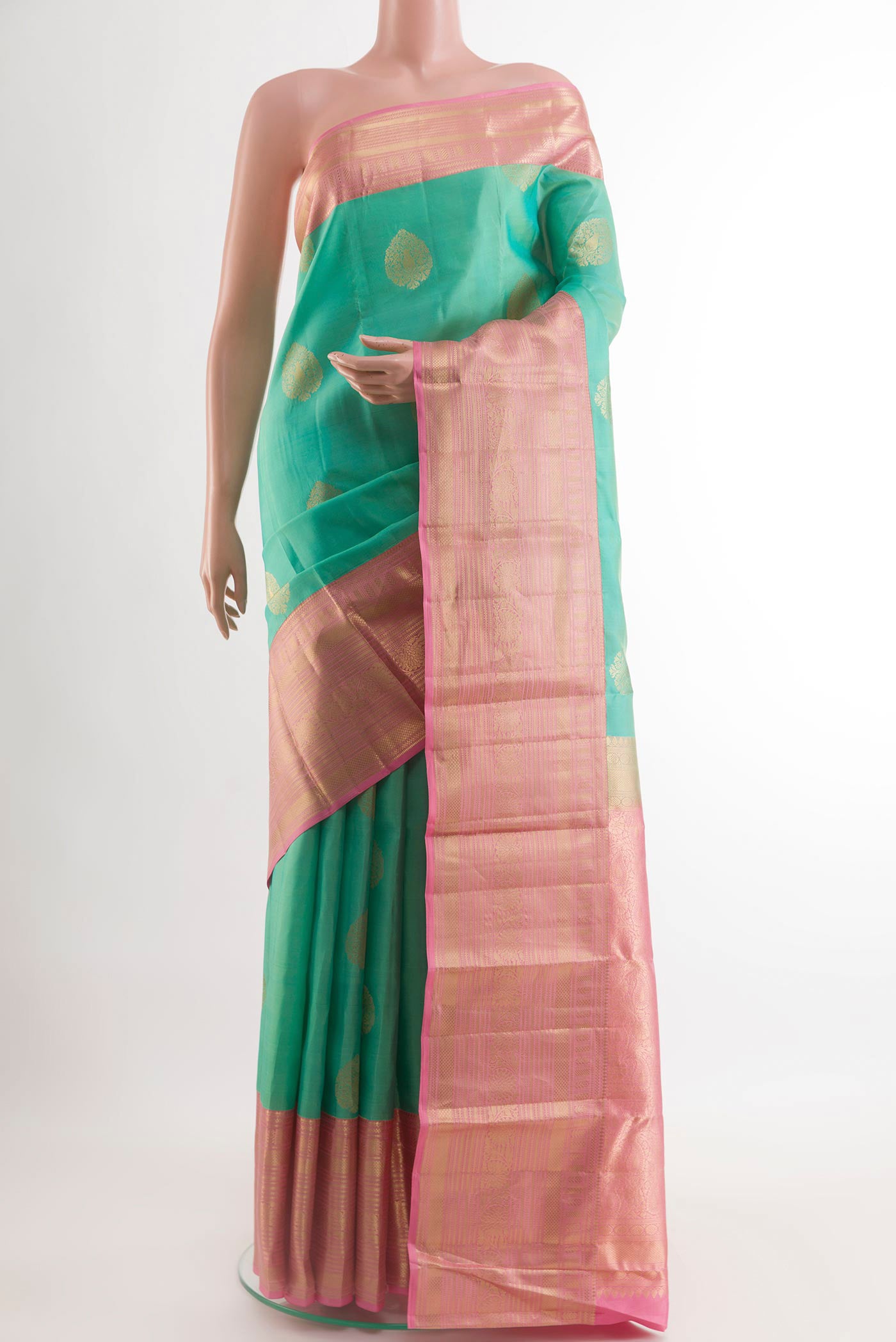 Sea Green Kanchipuram Silk Saree with Zari Butta on the body and Zari Border.  displayed on a mannequin