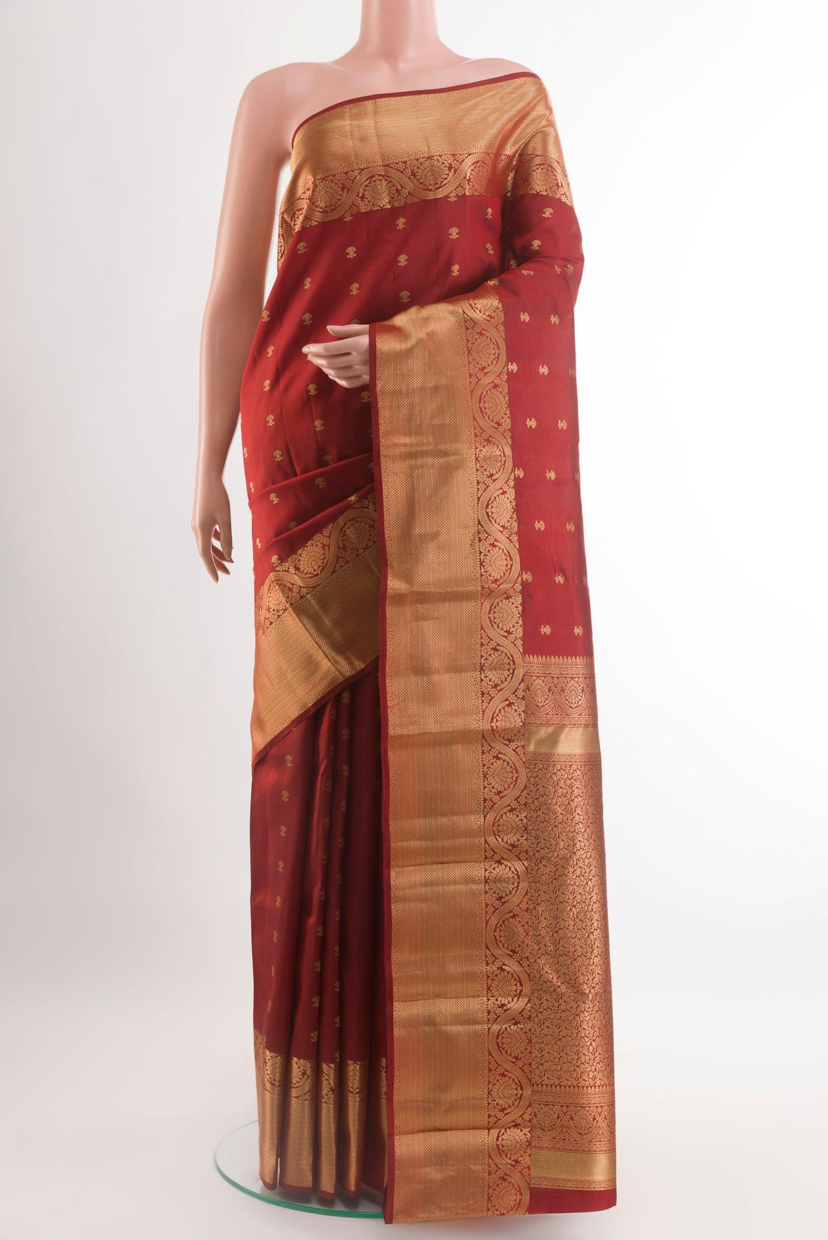 Maroon Kanchipuram Silk Saree with Zari Butta on the body and Zari Border.  displayed on a mannequin