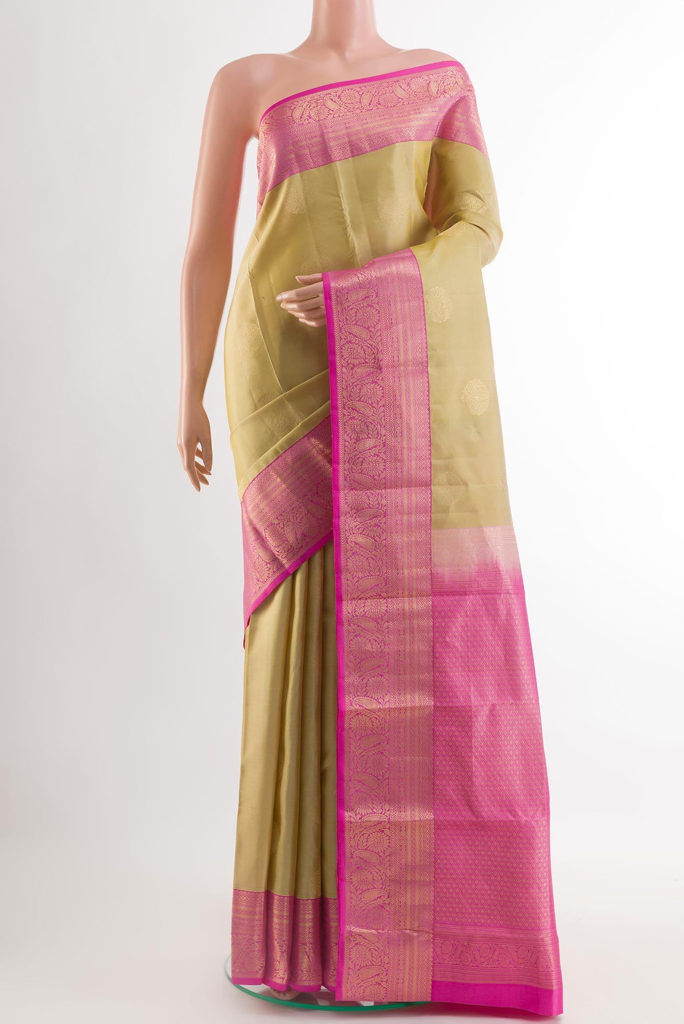 Beige Kanjivaram Silk Saree with Zari Butta on the body and Zari Border.  displayed on a mannequin