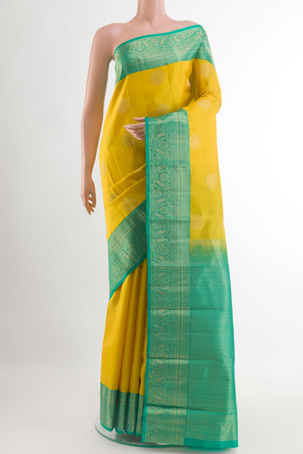 Yellow Kanjivaram Silk Saree with Zari Butta on the body and Zari Border.  displayed on a mannequin