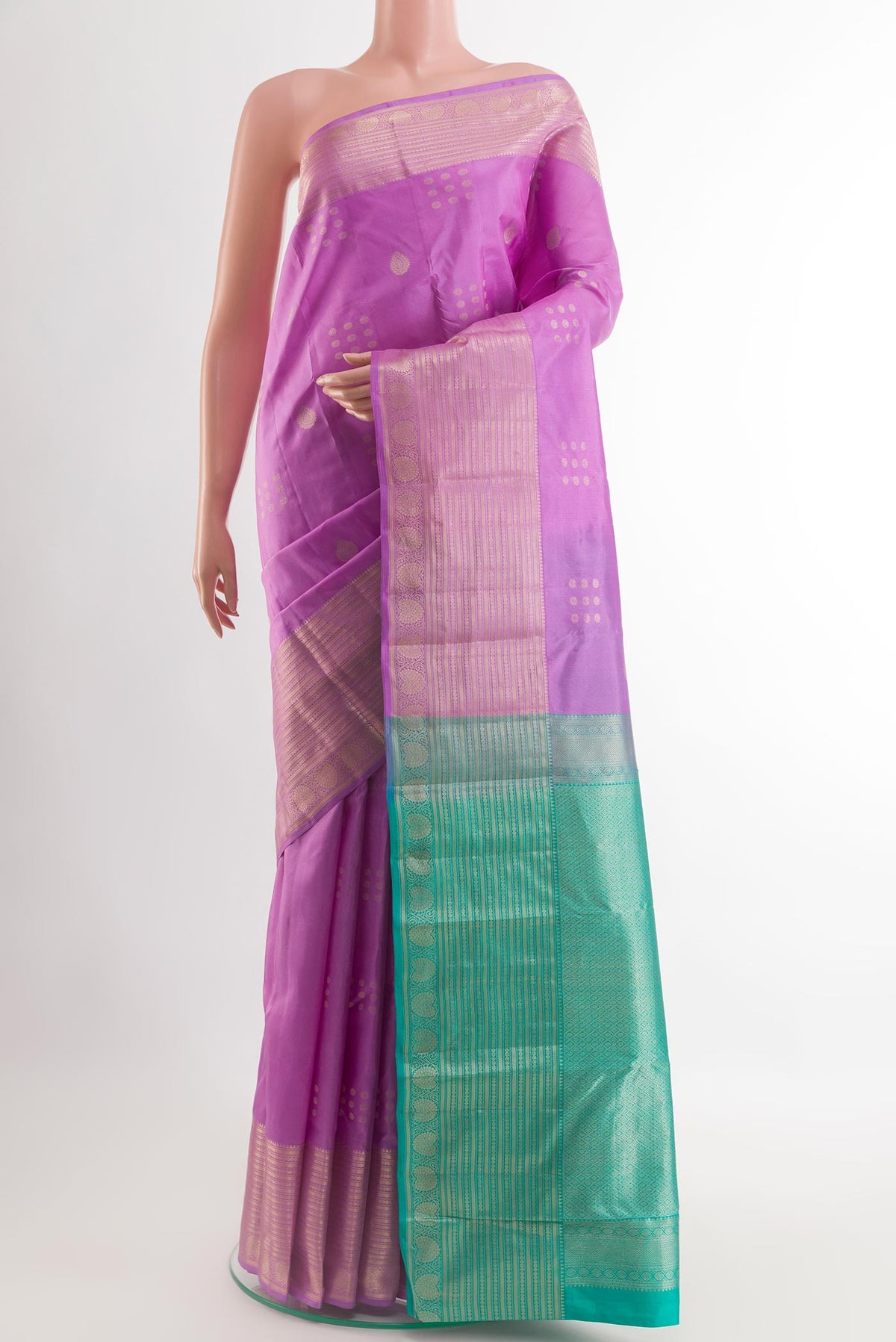 Lavender Kanchipuram Silk Saree with Zari Butta on the body and Zari Border.  displayed on a mannequin