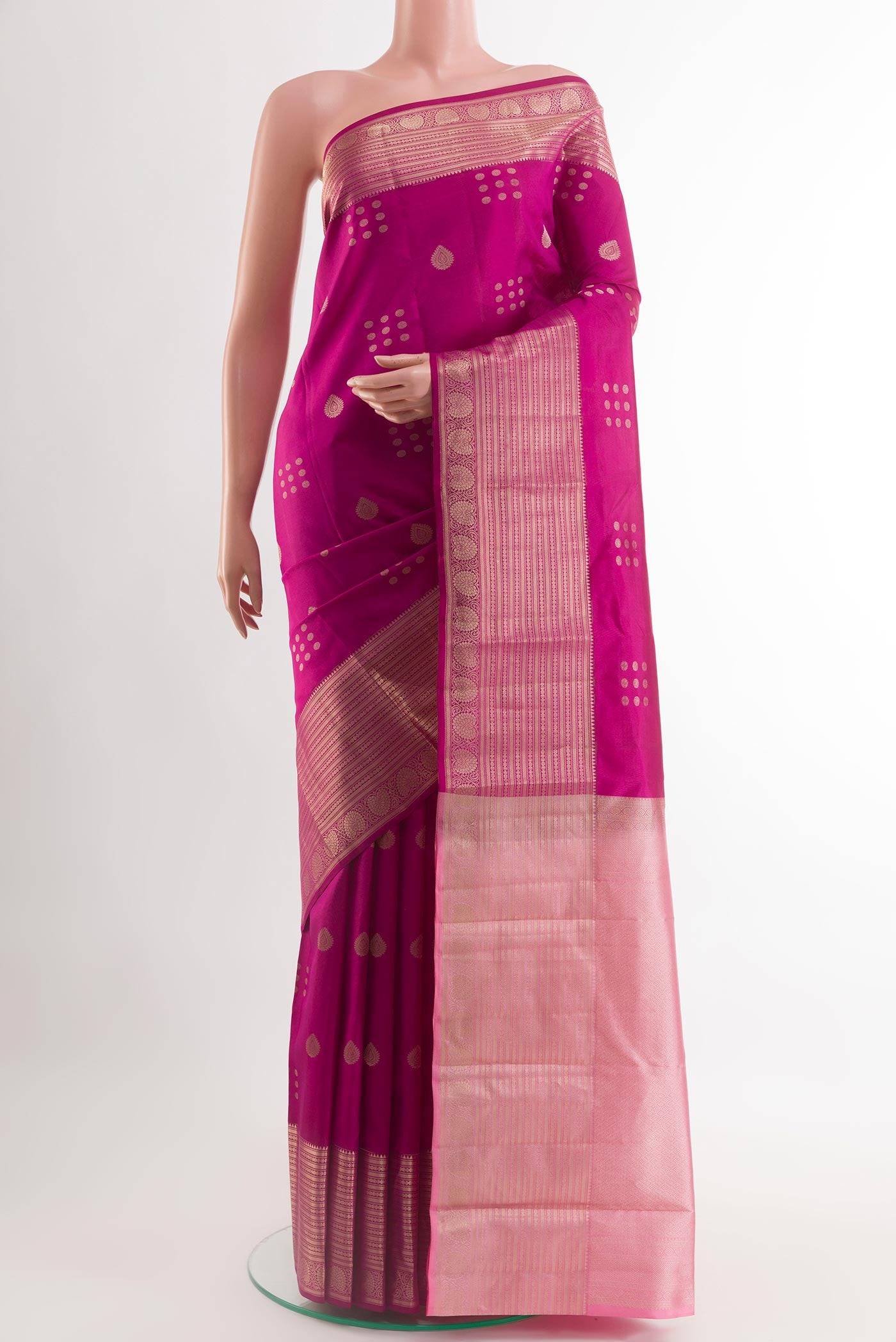 Magenta Kanchipuram Silk Saree with Zari Butta on the body and Zari Border.  displayed on a mannequin