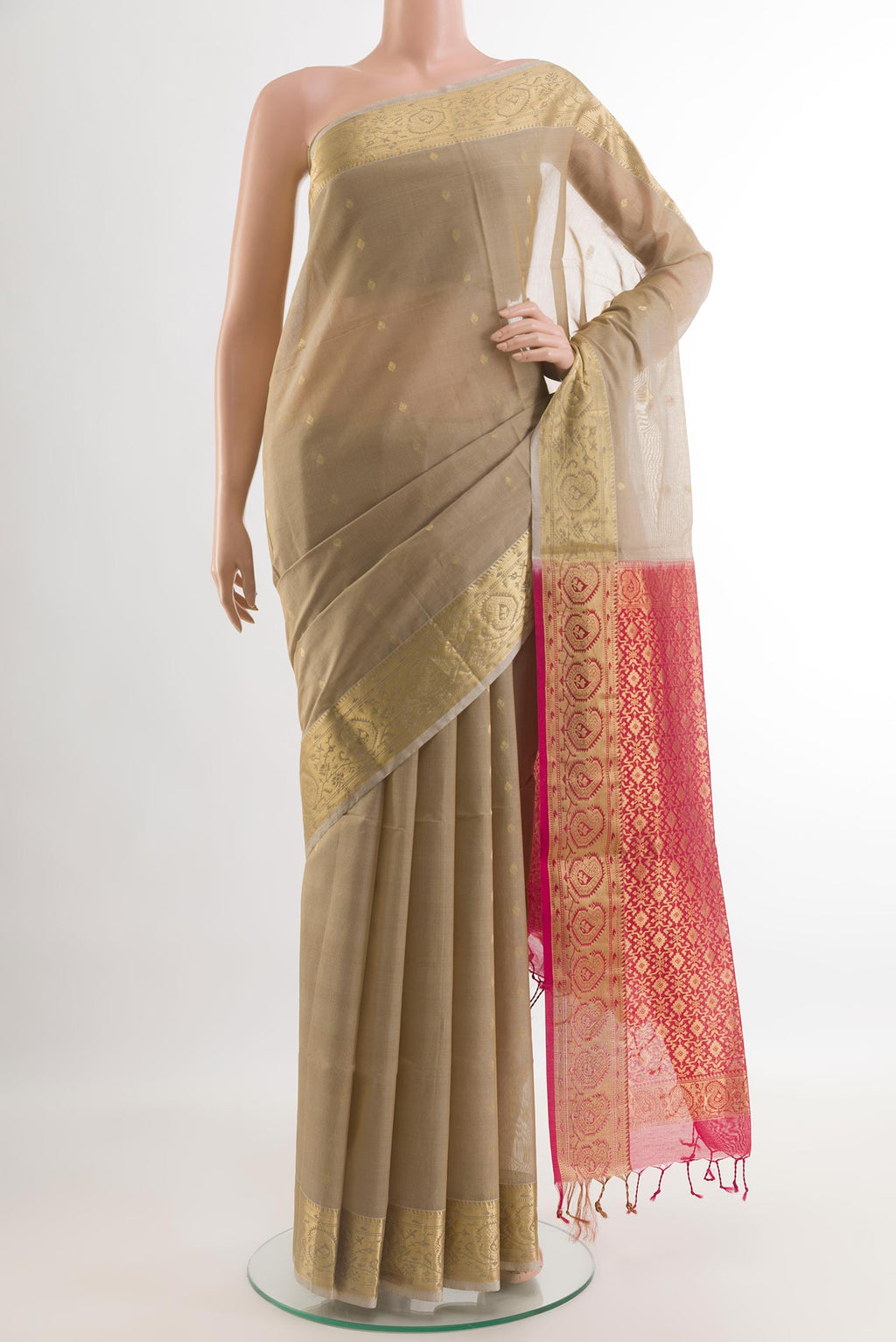 Beige Silk Cotton Saree with Zari Butta on the body and Zari Border.  displayed on a mannequin