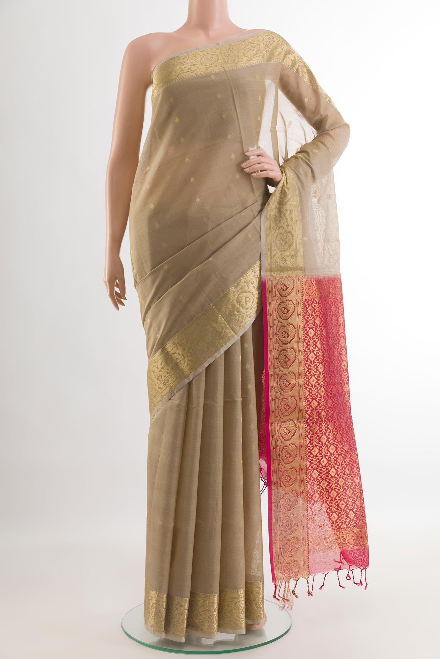 Beige Silk Cotton Saree with Zari Butta on the body and Zari Border.  displayed on a mannequin