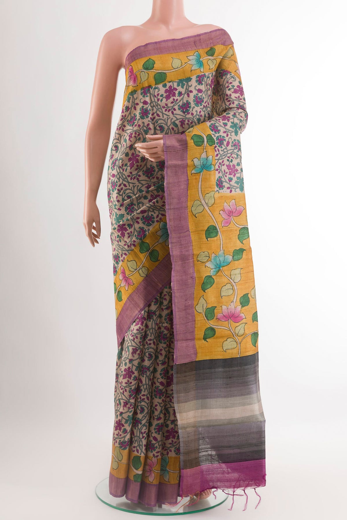 Cream Tussar Saree with Printed design on the body and Printed Border.  displayed on a mannequin