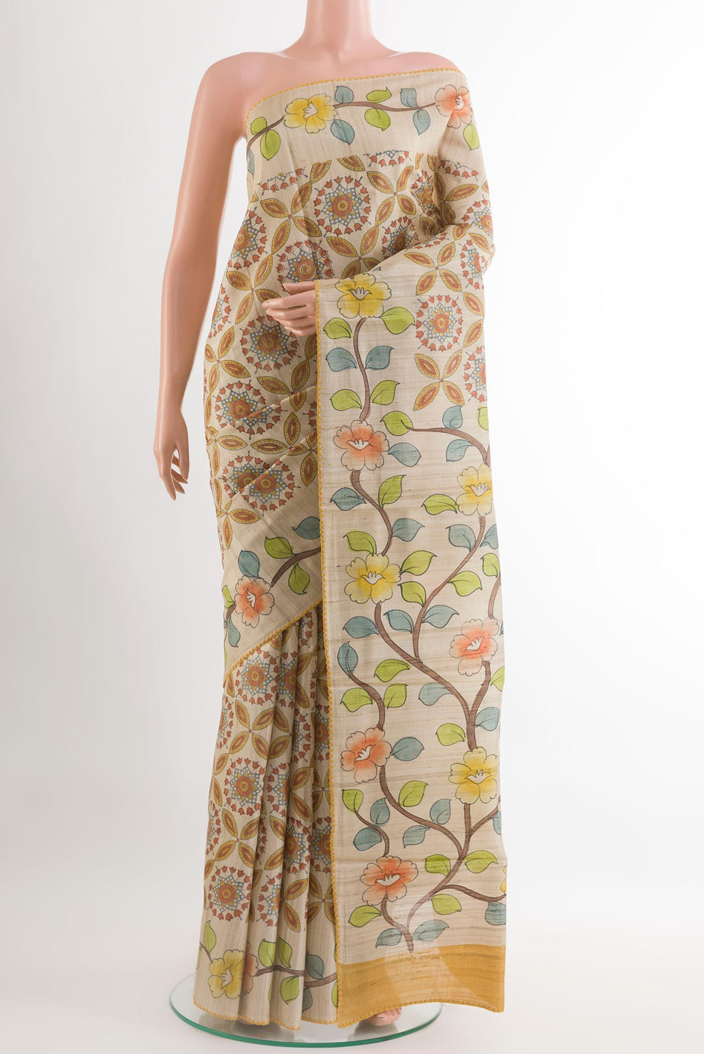 Yellow Tussar Saree with Printed design on the body and Embroidery Border.  displayed on a mannequin