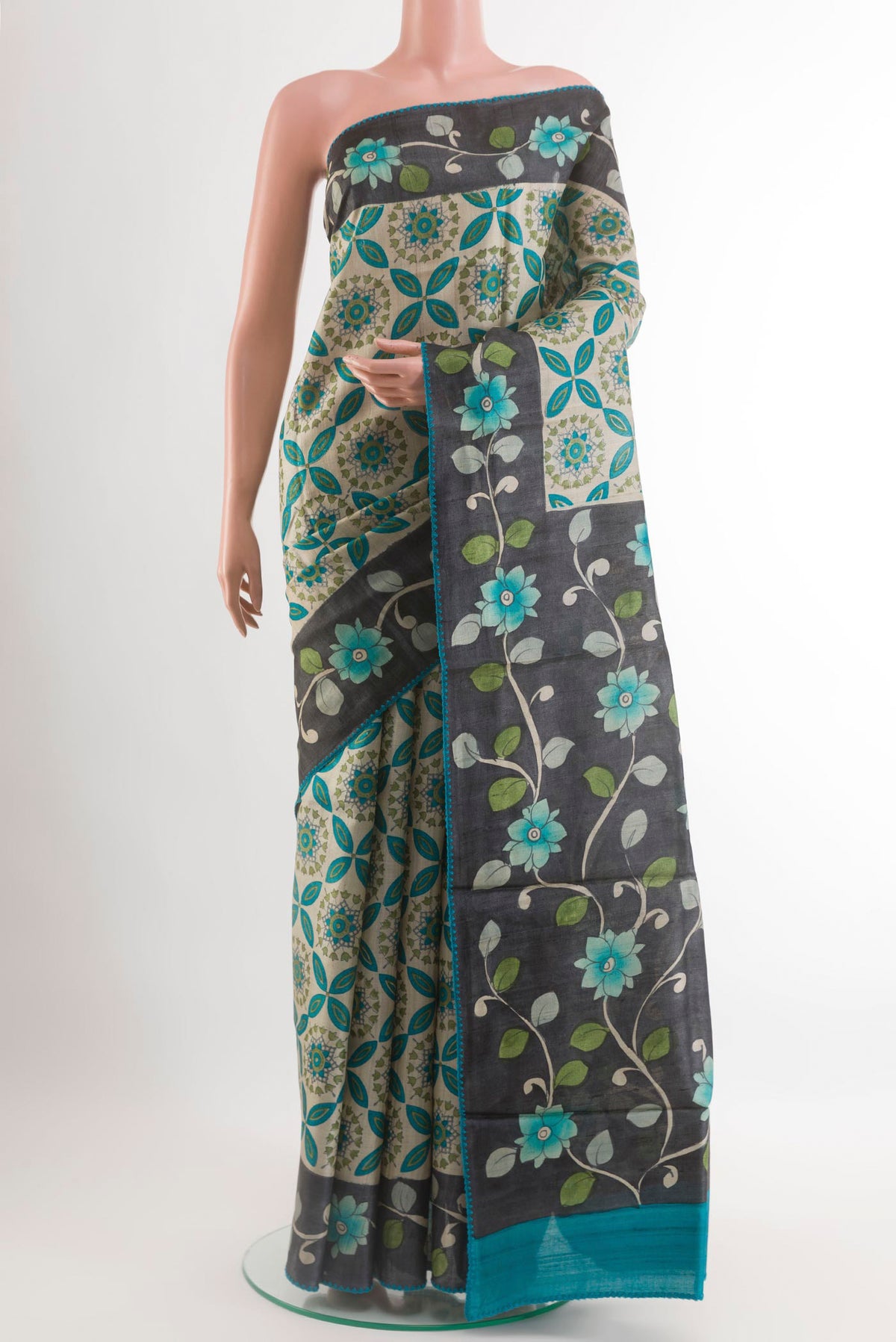 Off White Tussar Saree with Printed design on the body and Printed Border.  displayed on a mannequin