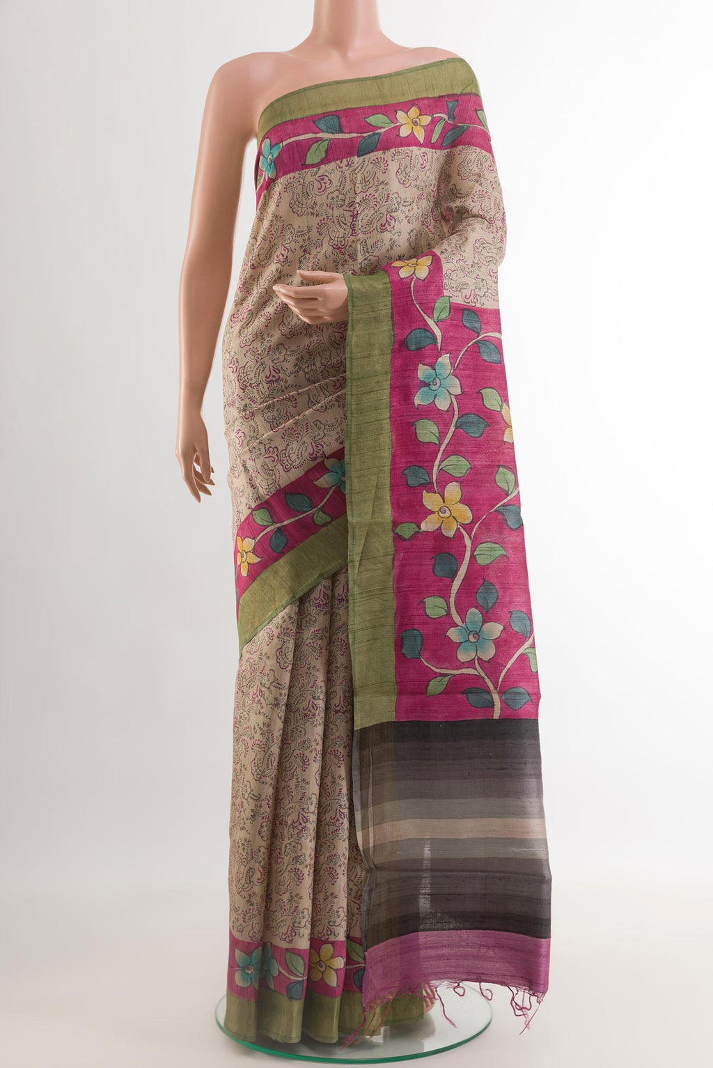 Beige Tussar Silk Saree with Printed design on the body and Zari Border.  displayed on a mannequin