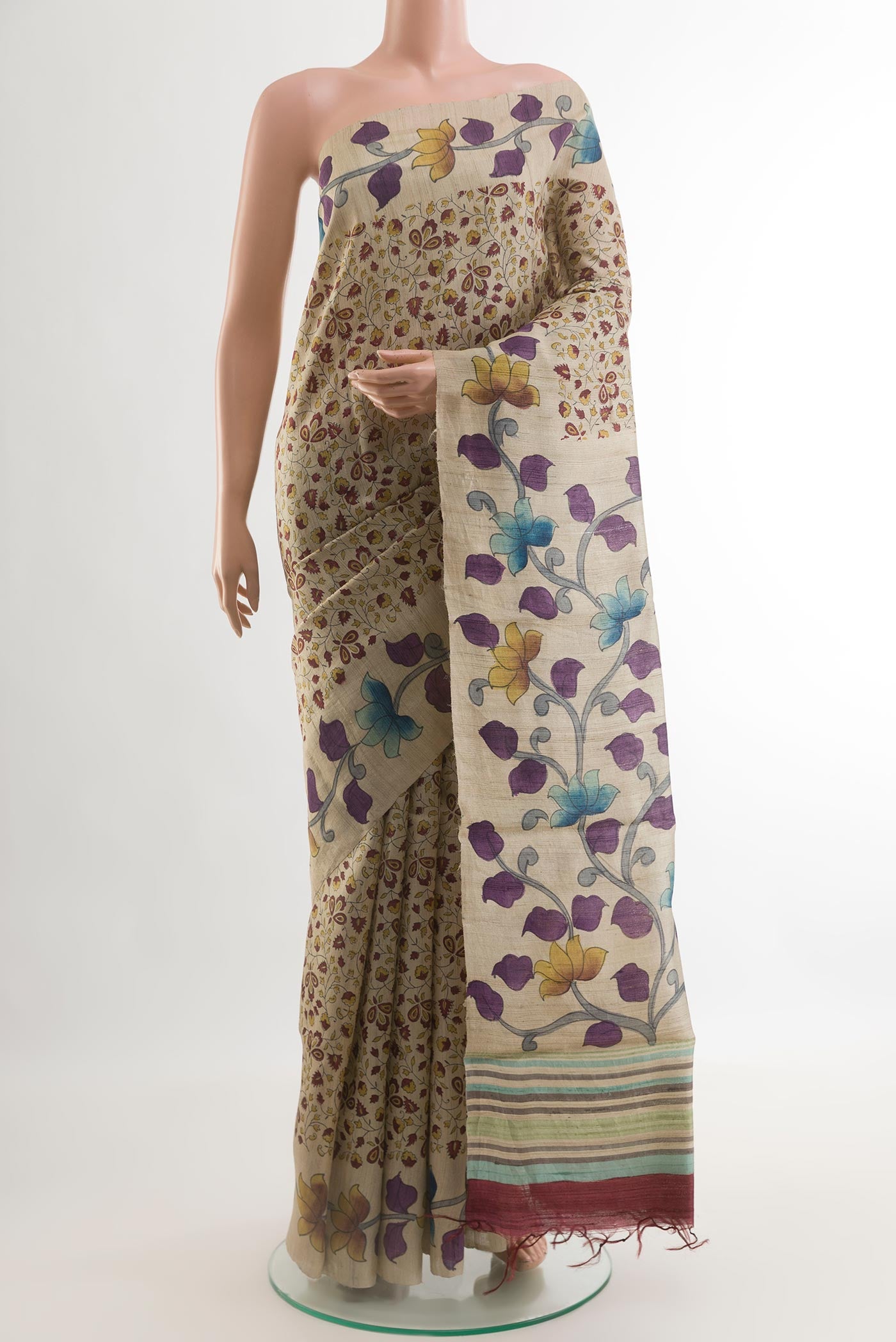 Beige Tussar Silk Saree with Printed design on the body and Without Border.  displayed on a mannequin