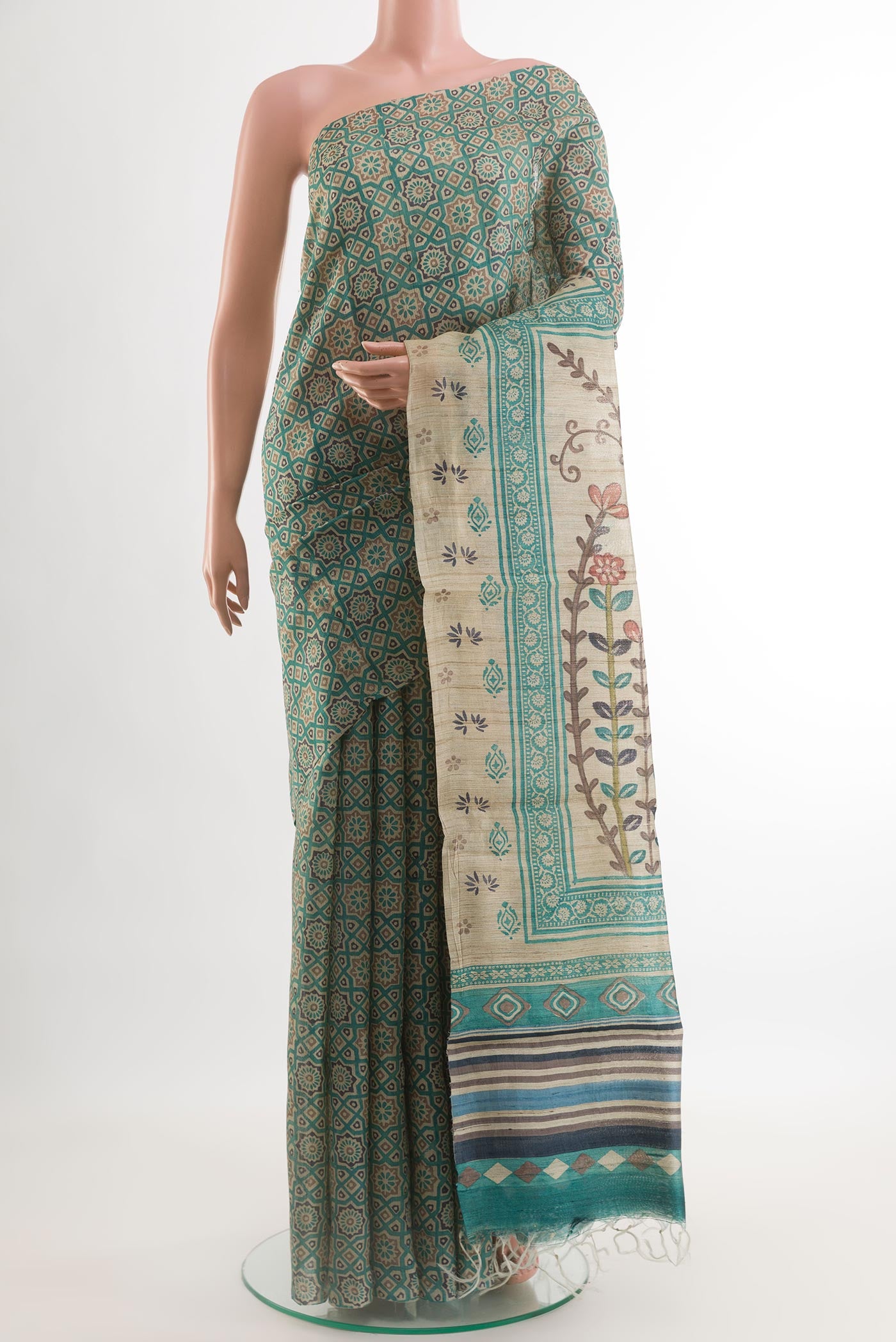 Teal Tussar Silk Saree with Printed design on the body and Without Border.  displayed on a mannequin