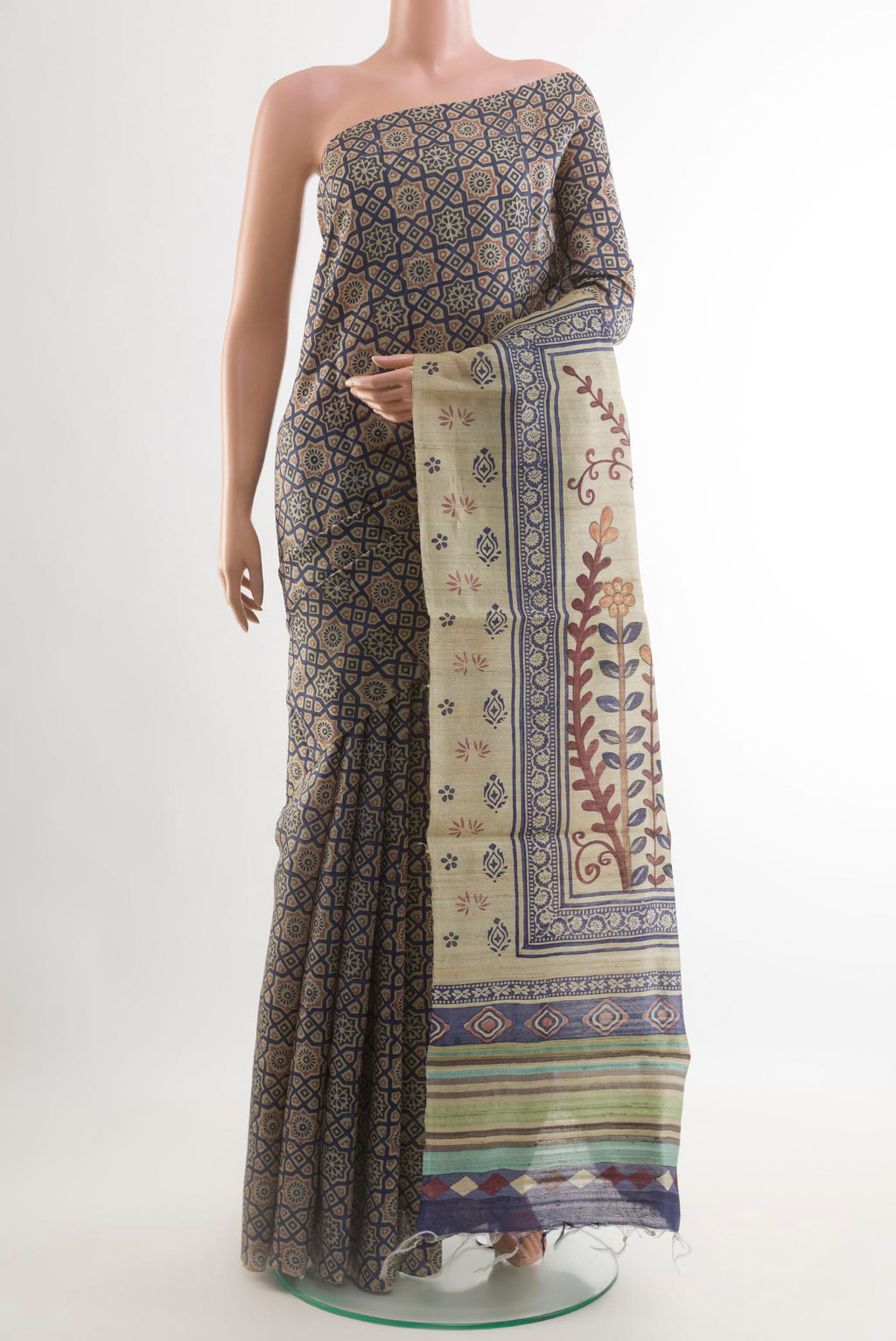 Beige Tussar Saree with Printed design on the body and Printed Border.  displayed on a mannequin