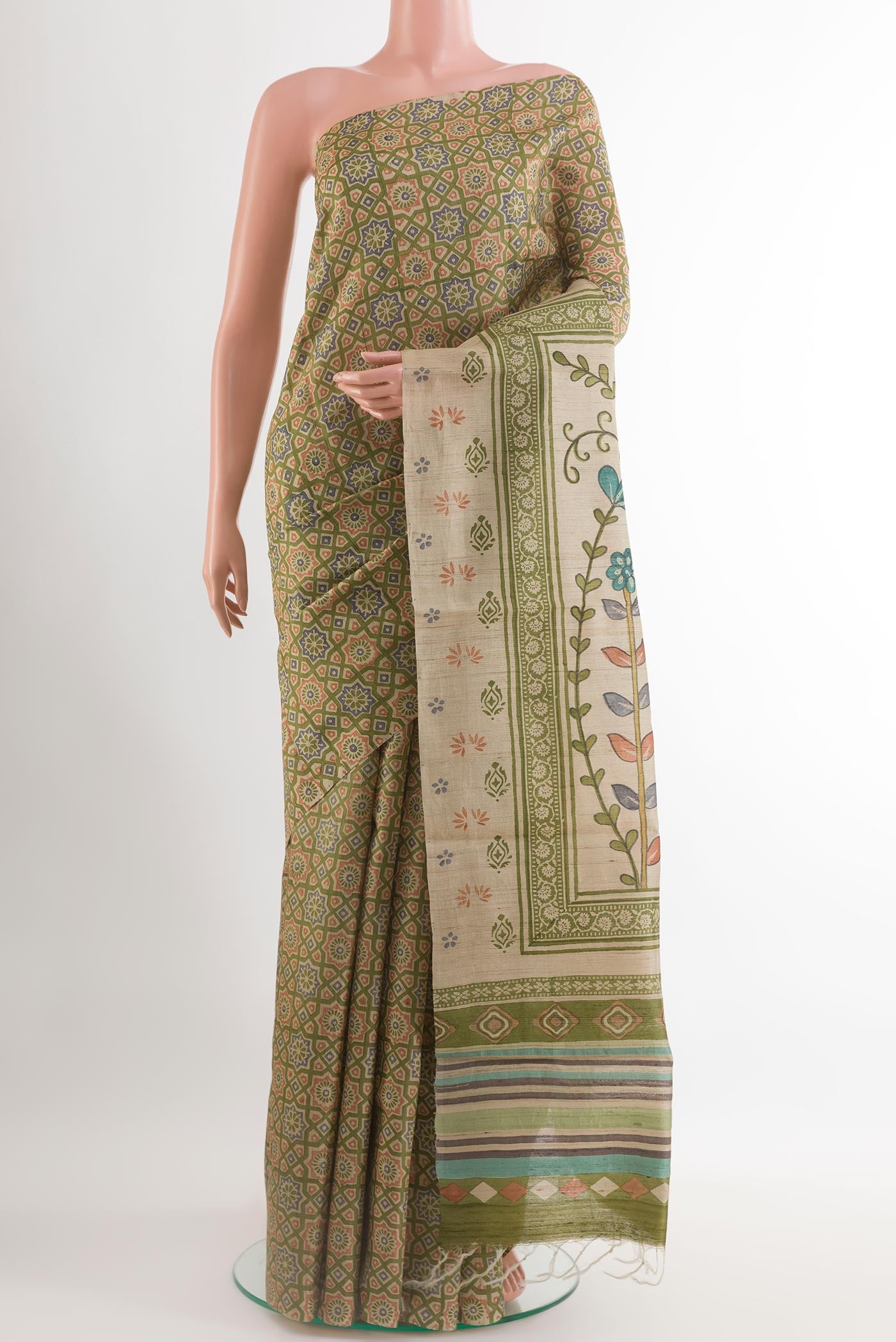 Green Tussar Saree with Printed design on the body and Embroidery Border.  displayed on a mannequin