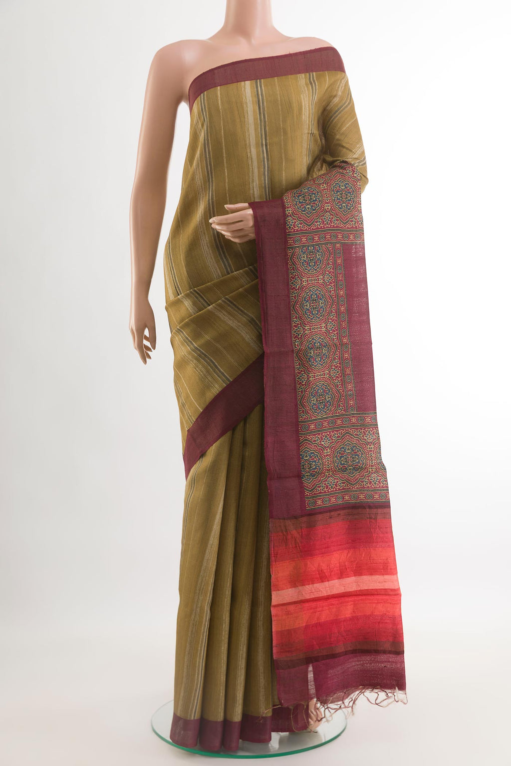 Mustard Tussar Saree with Printed design on the body and Zari Border.  displayed on a mannequin