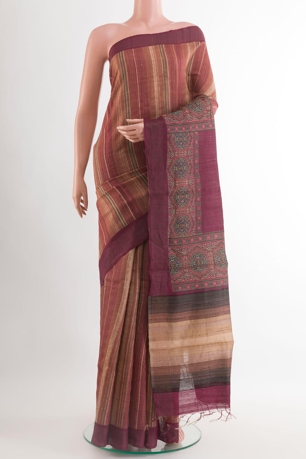 Maroon Tussar Saree with Printed design on the body and Embroidery Border.  displayed on a mannequin