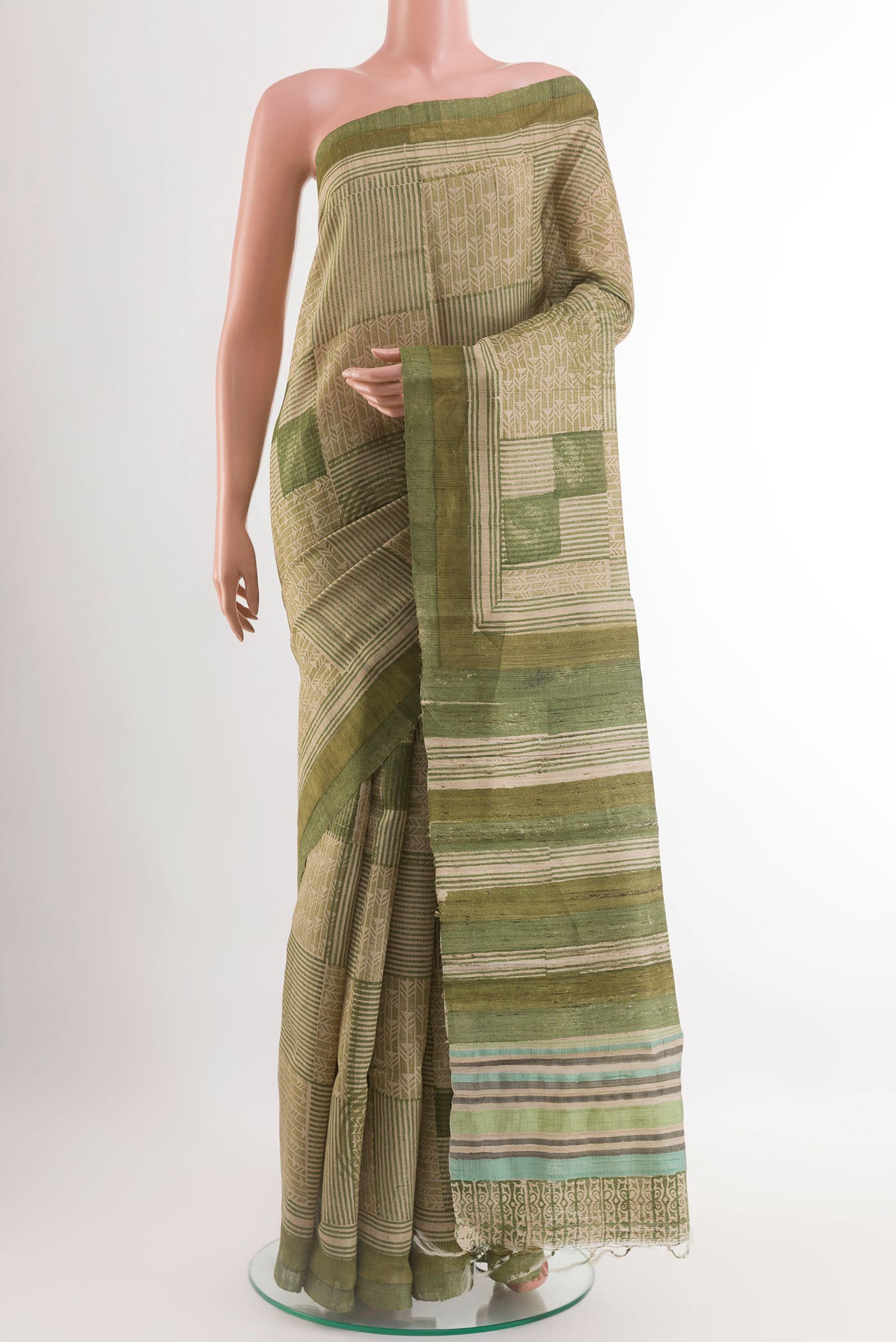 Green Tussar Saree with Printed design on the body and Printed Border.  displayed on a mannequin