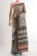 Black Tussar Saree with Printed design on the body and Printed Border.  displayed on a mannequin