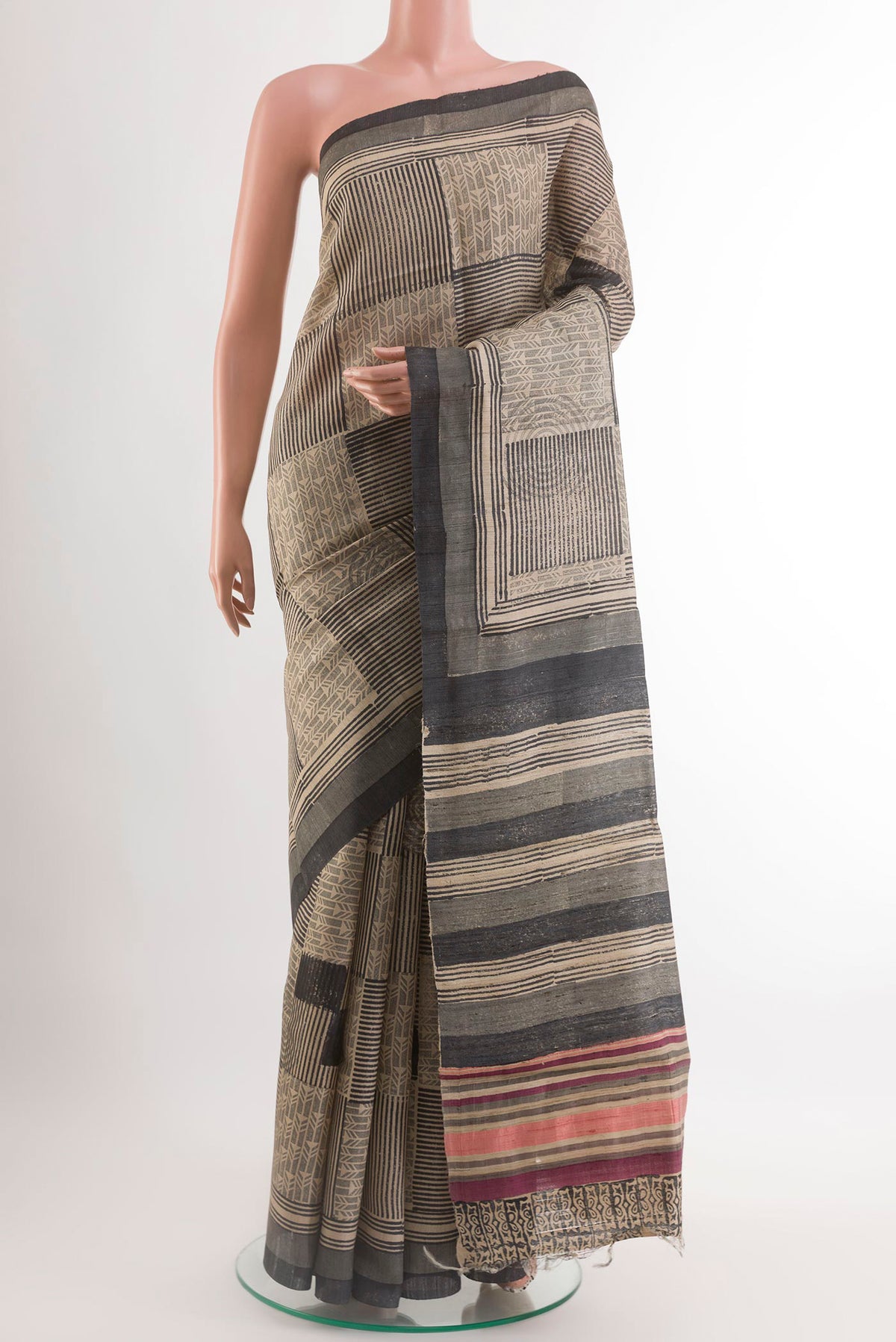 Black Tussar Saree with Printed design on the body and Printed Border.  displayed on a mannequin