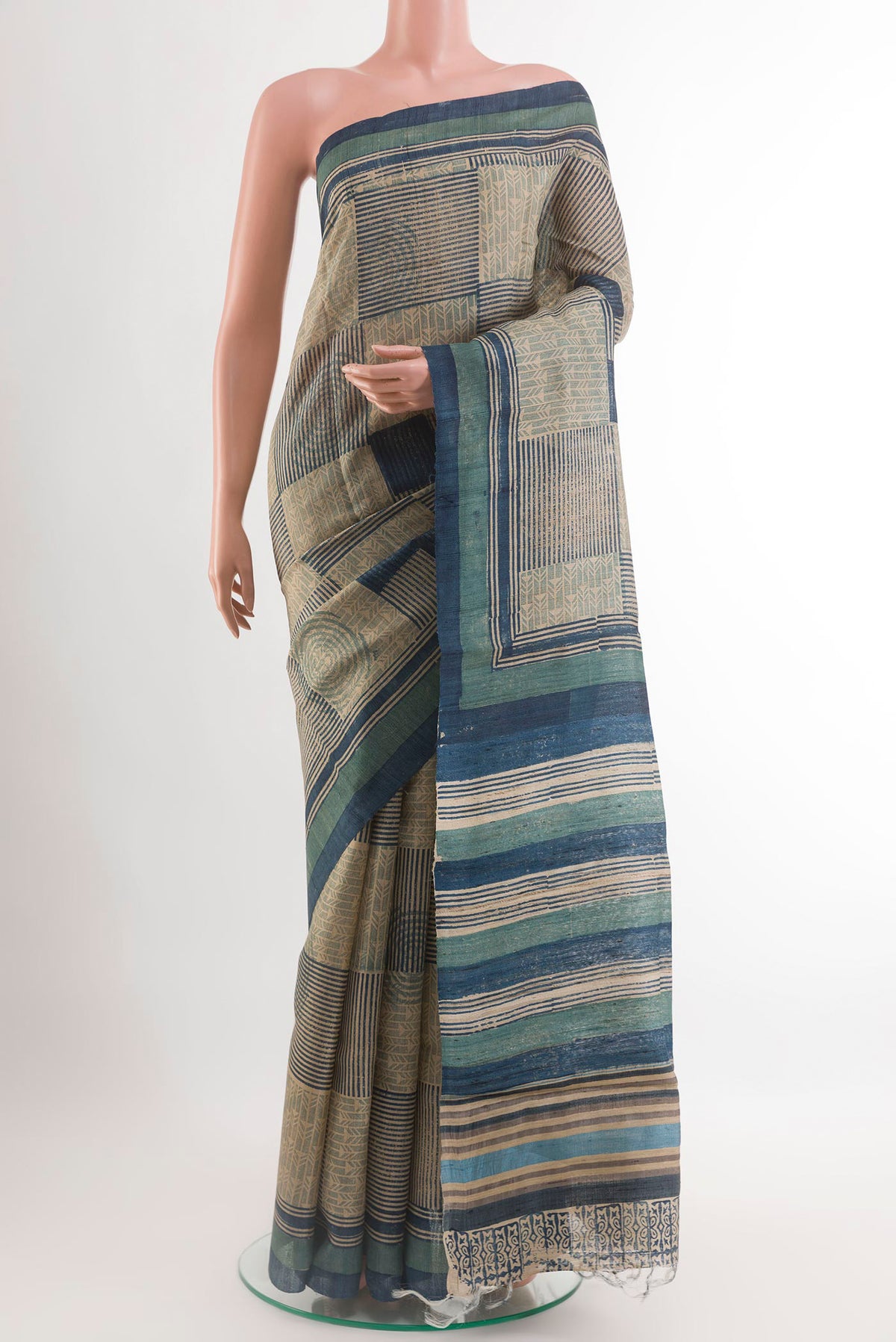 Blue Tussar Saree with Printed design on the body and Printed Border.  displayed on a mannequin