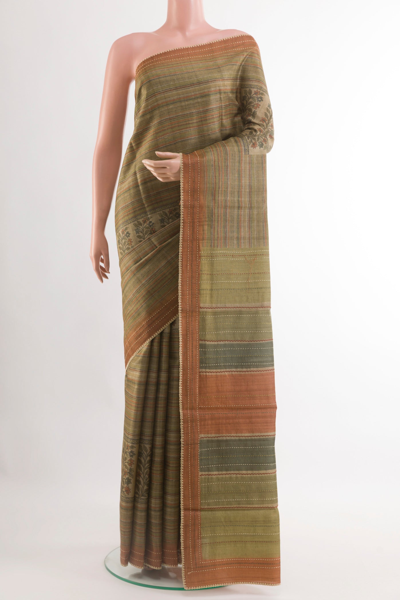 Green Tussar Saree with Printed design on the body and Zari Border.  displayed on a mannequin