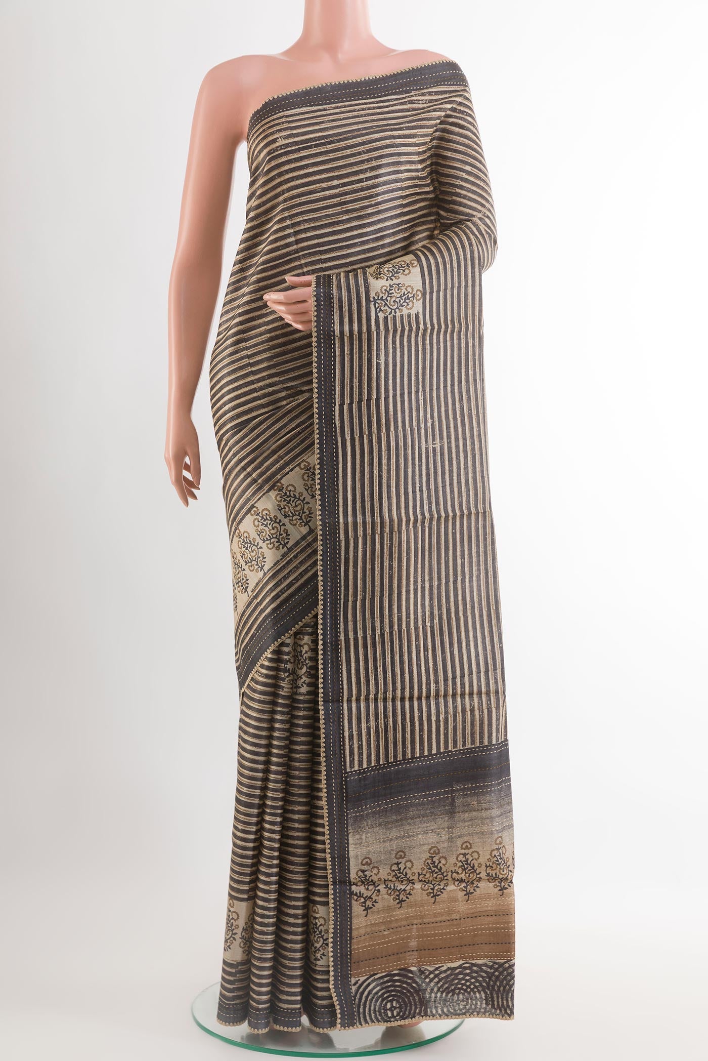 Black Tussar Saree with Printed design on the body and Embroidery Border.  displayed on a mannequin