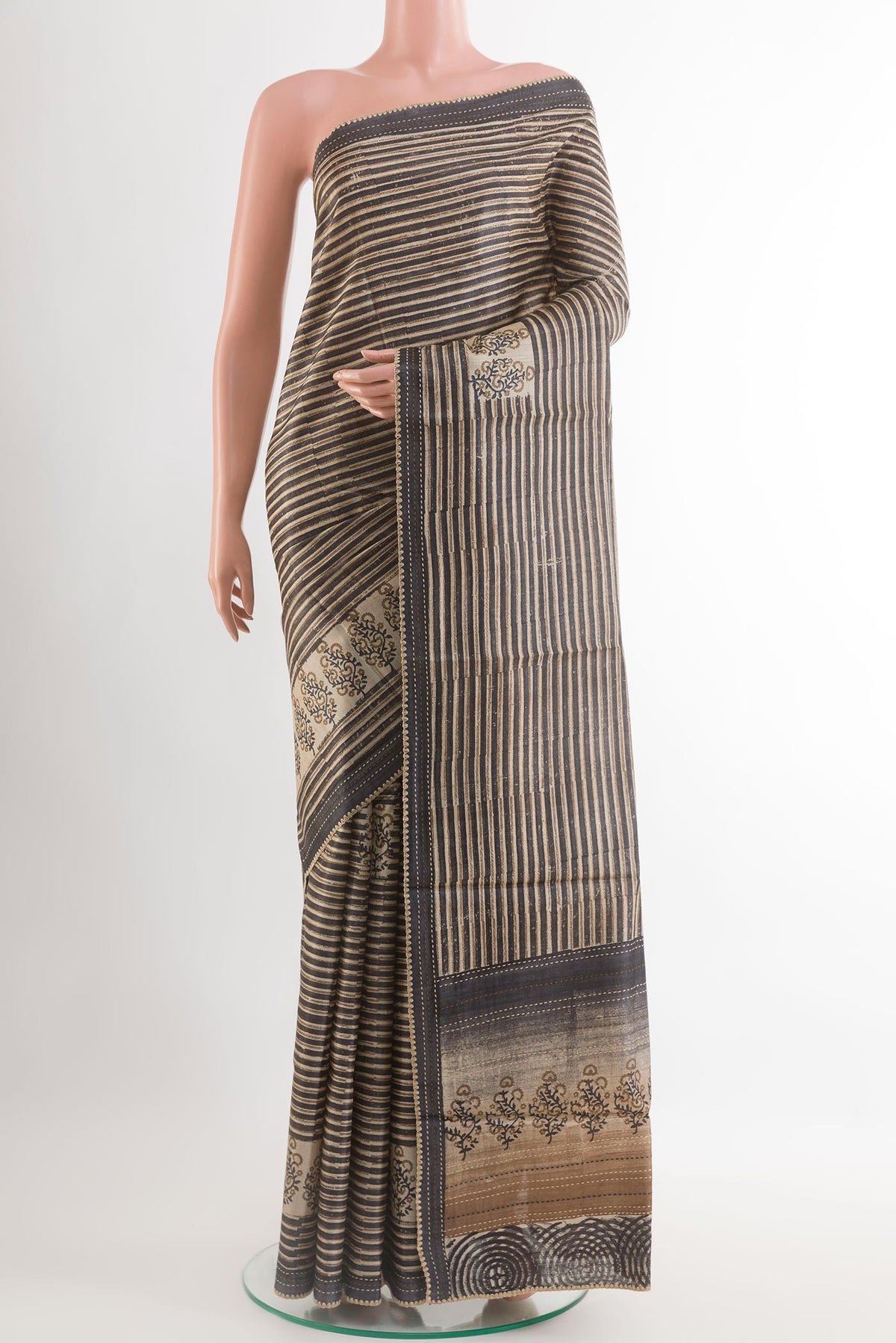 Black Tussar Saree with Printed design on the body and Embroidery Border.  displayed on a mannequin
