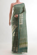 Green Tussar Silk Saree with Printed design on the body and Printed Border.  displayed on a mannequin