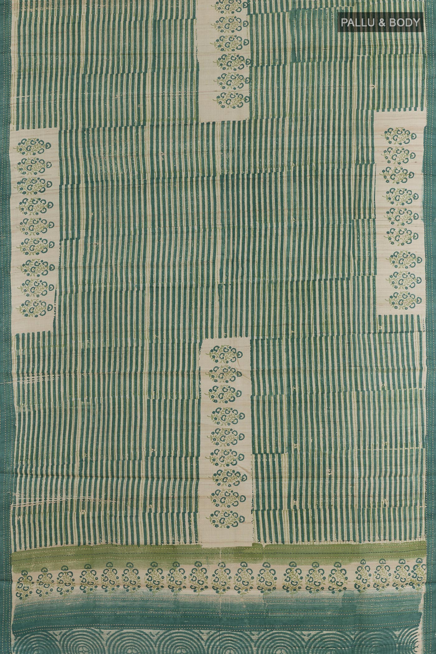 Flat view of Green Tussar Silk Saree with Printed design on the body and Printed Border. 