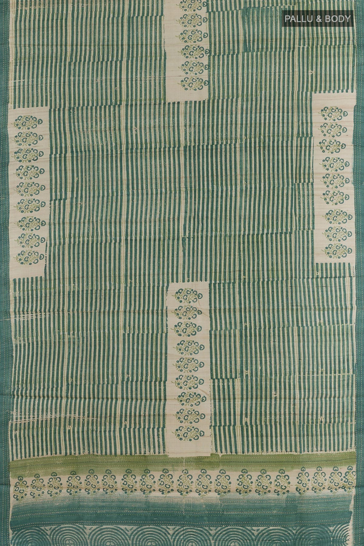 Flat view of Green Tussar Silk Saree with Printed design on the body and Printed Border. 