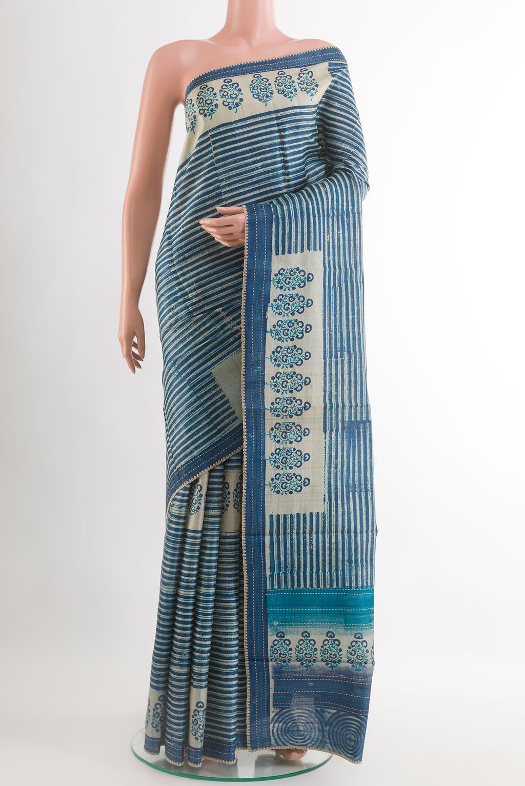 Blue Tussar Saree with Printed design on the body and Embroidery Border.  displayed on a mannequin