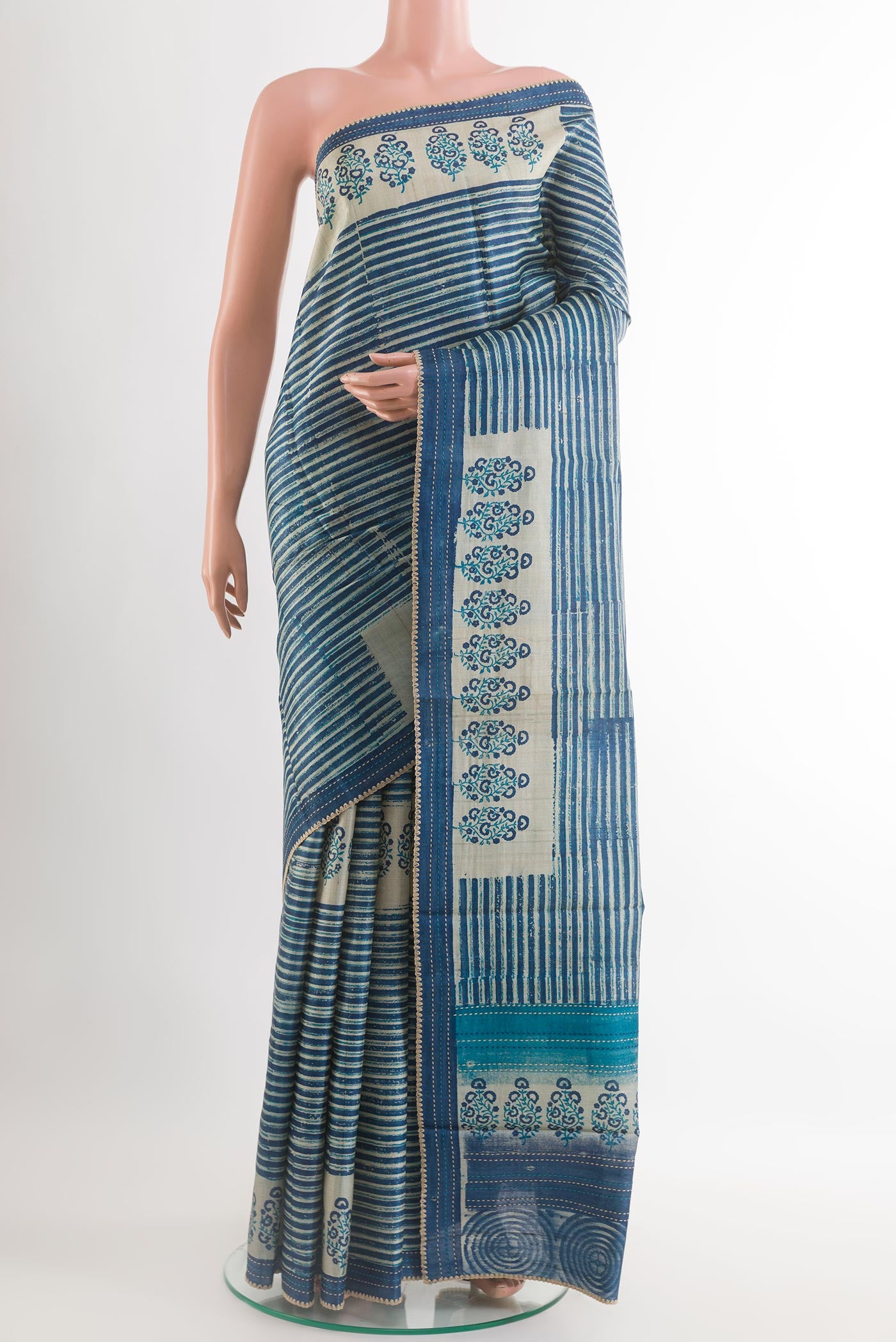 Blue Tussar Saree with Printed design on the body and Embroidery Border.  displayed on a mannequin