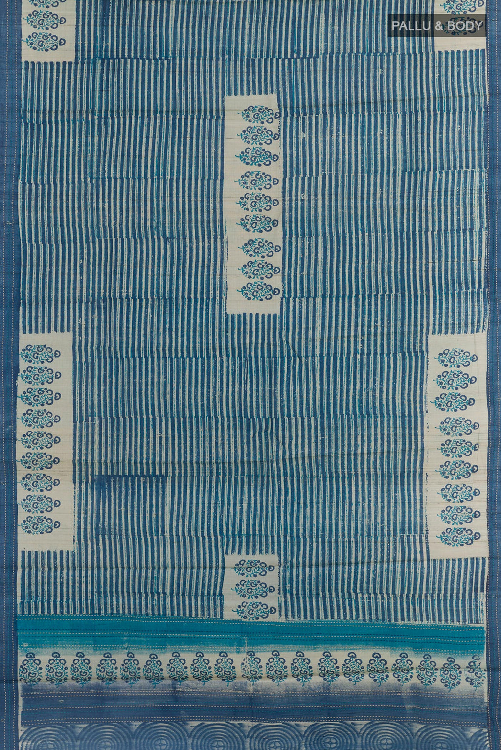 Flat view of Blue Tussar Saree with Printed design on the body and Embroidery Border. 