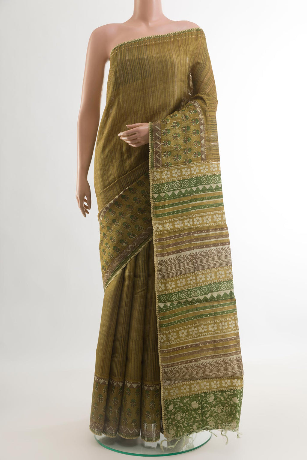 Mehandi Green Tussar Saree with Printed design on the body and Printed Border.  displayed on a mannequin
