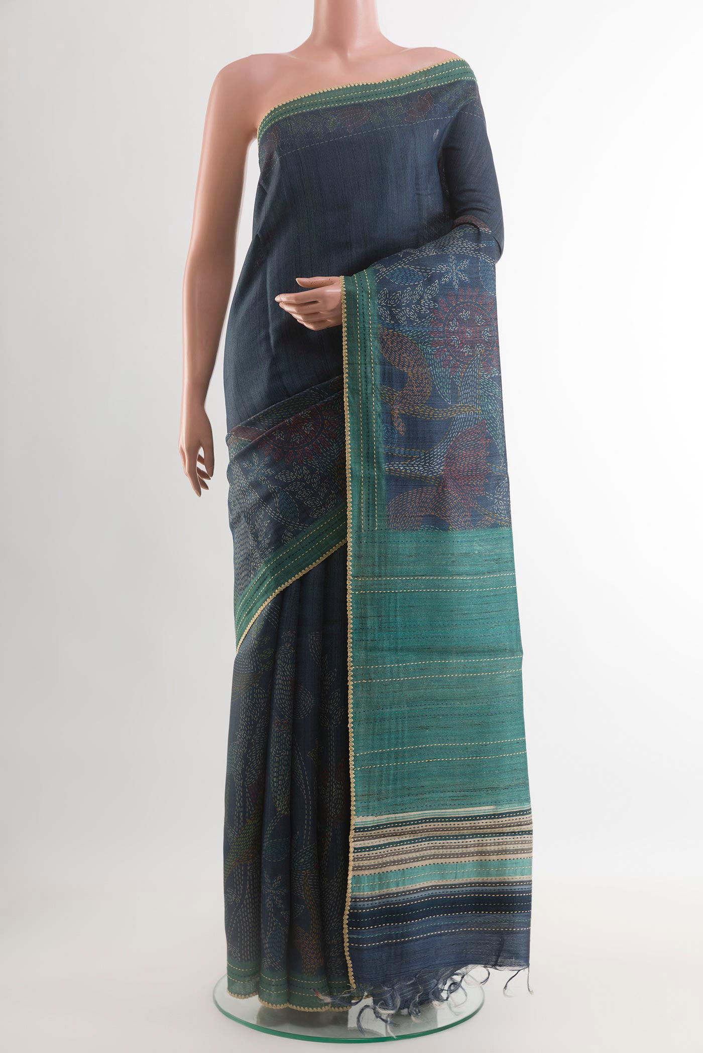 Blue Tussar Saree with Printed design on the body and Embroidery Border.  displayed on a mannequin