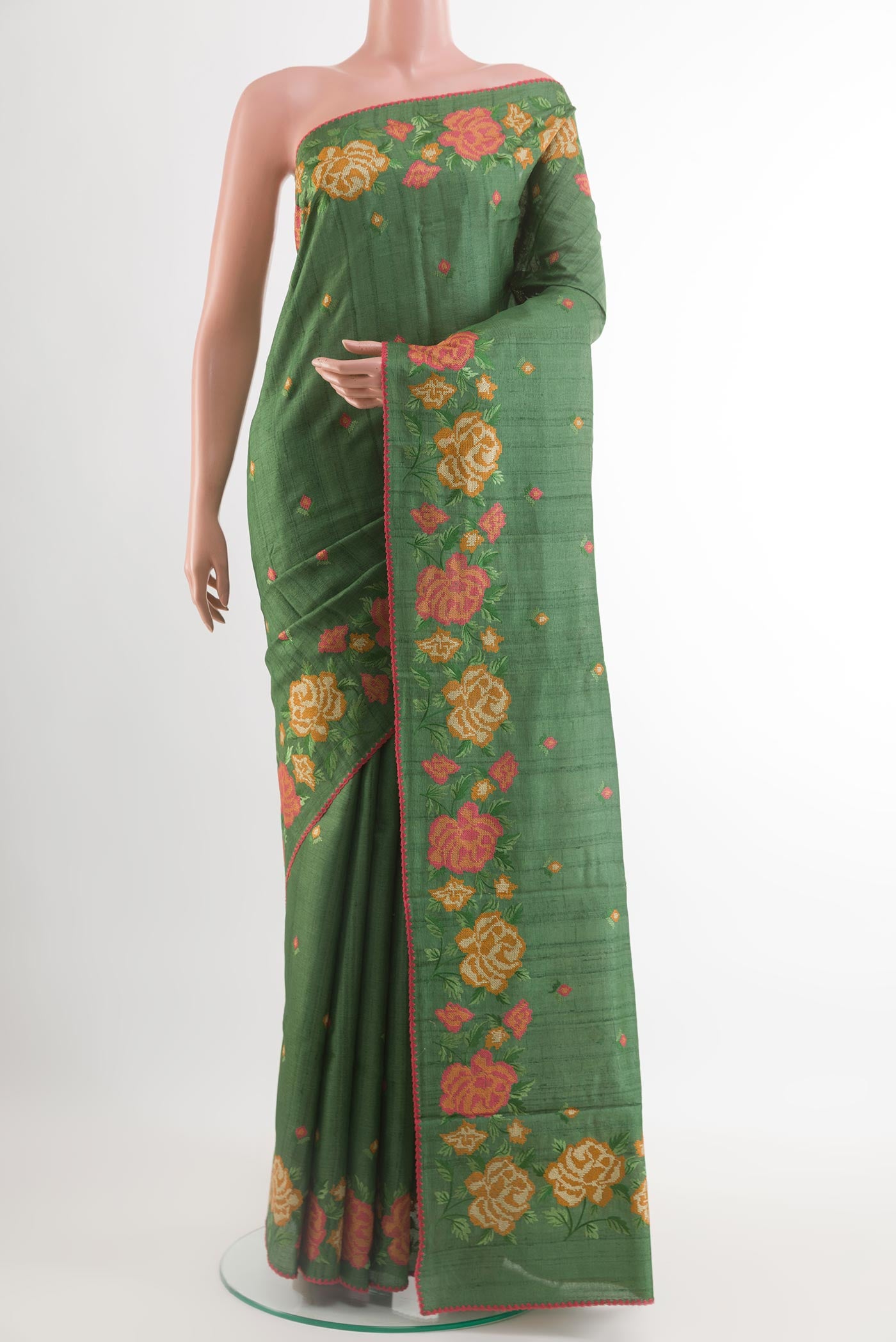 Green Tussar Saree with Thread Butta on the body and Embroidery Border.  displayed on a mannequin