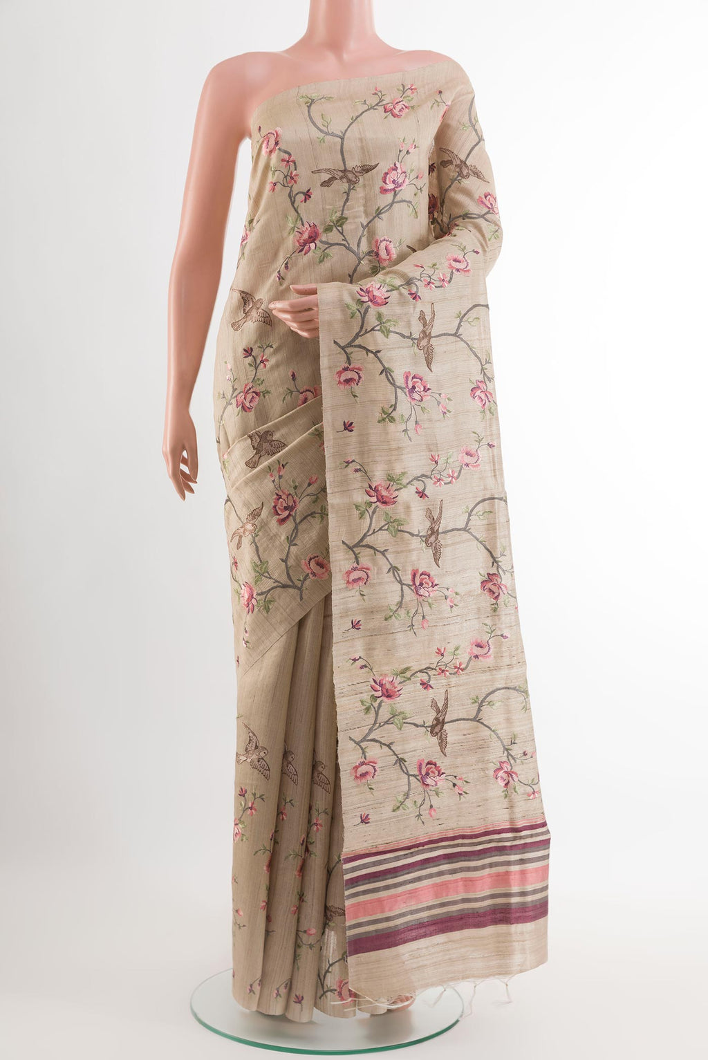Beige Tussar Saree with Embroidery on the body and Embroidery Border.  displayed on a mannequin