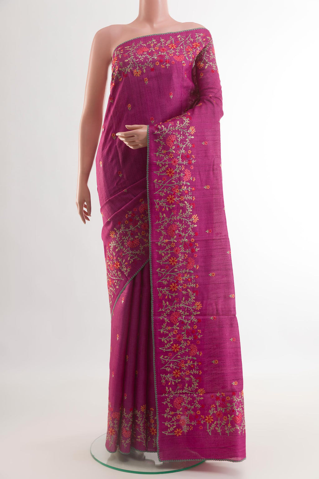 Magenta Tussar Silk Saree with Embroidery on the body and Embroidery Border.  displayed on a mannequin