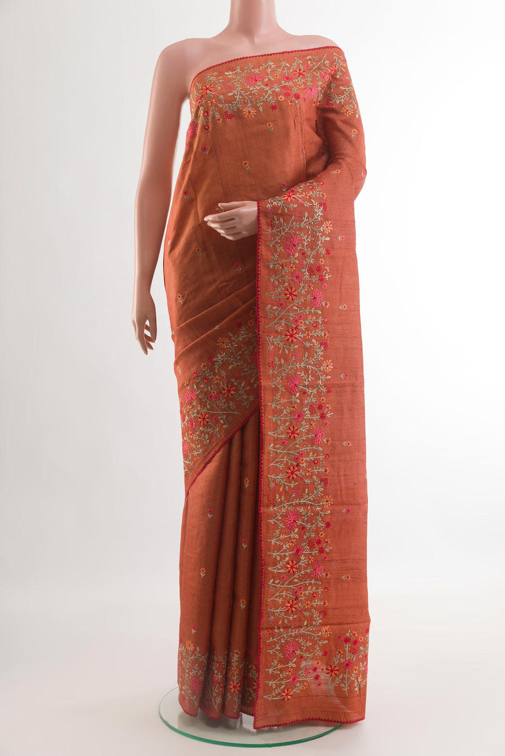 Brick Orange Tussar Saree with Embroidery on the body and Embroidery Border.  displayed on a mannequin