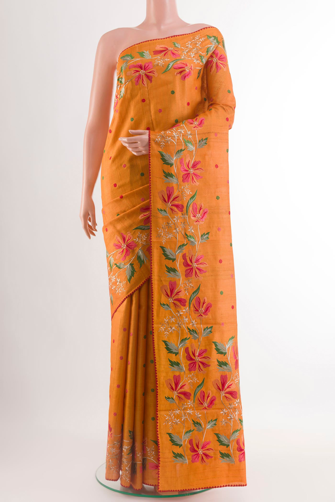 Orange Tussar Saree with Embroidery on the body and Embroidery Border.  displayed on a mannequin