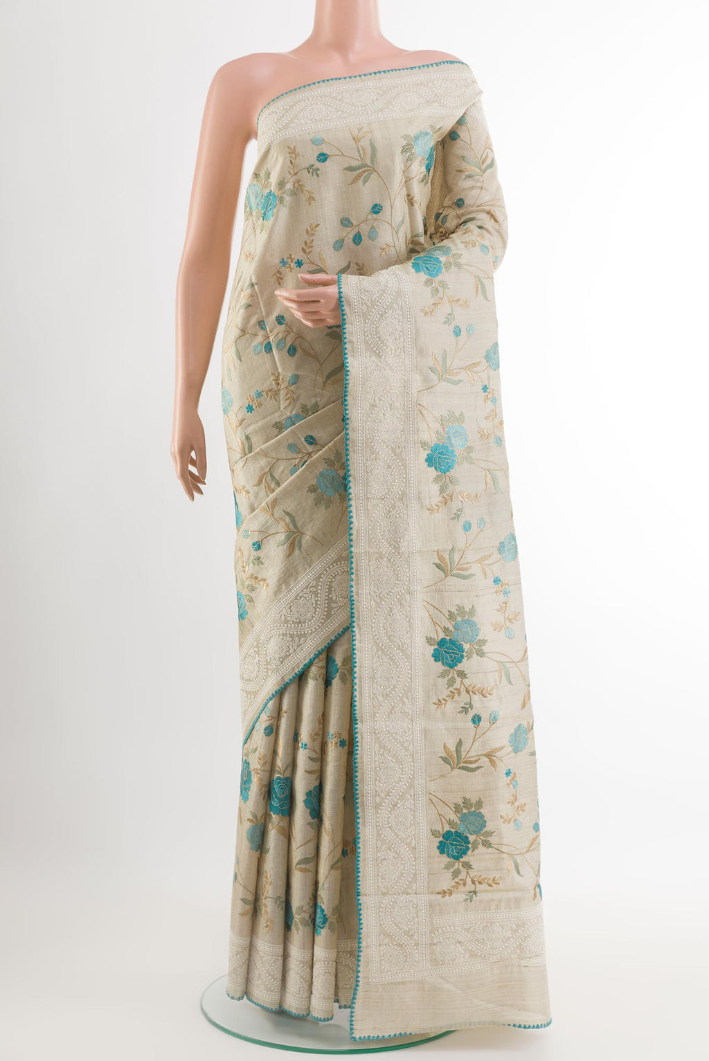 Cream Tussar Saree with Thread Butta on the body and Embroidery Border.  displayed on a mannequin