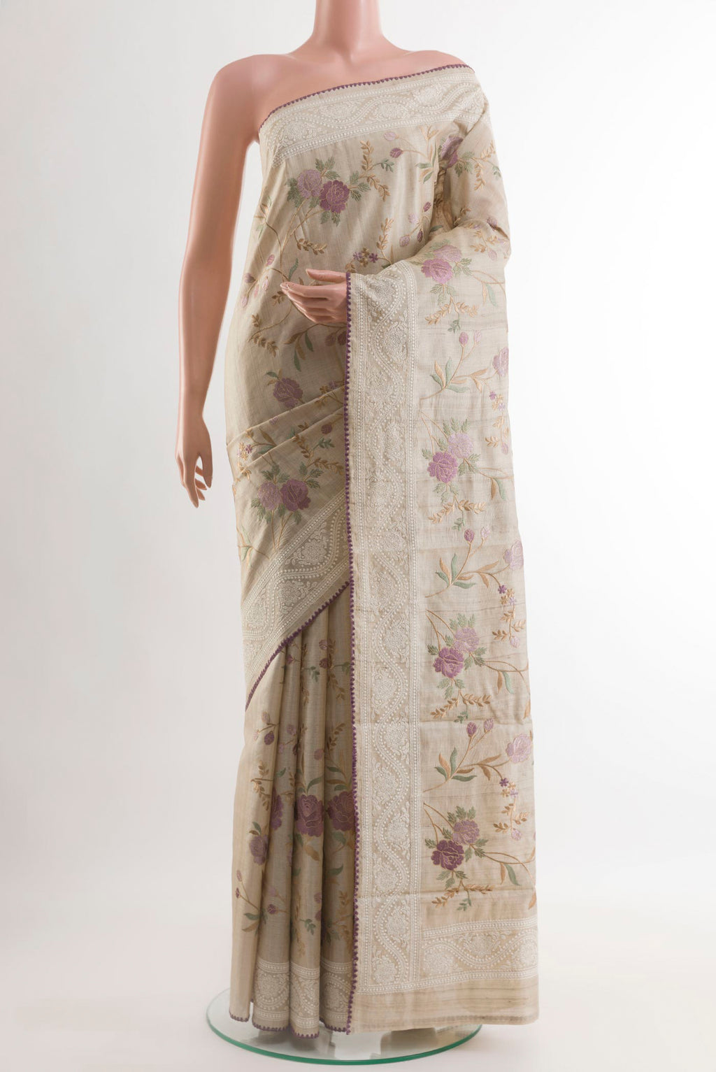 Off White Tussar Saree with Embroidery on the body and Embroidery Border.  displayed on a mannequin