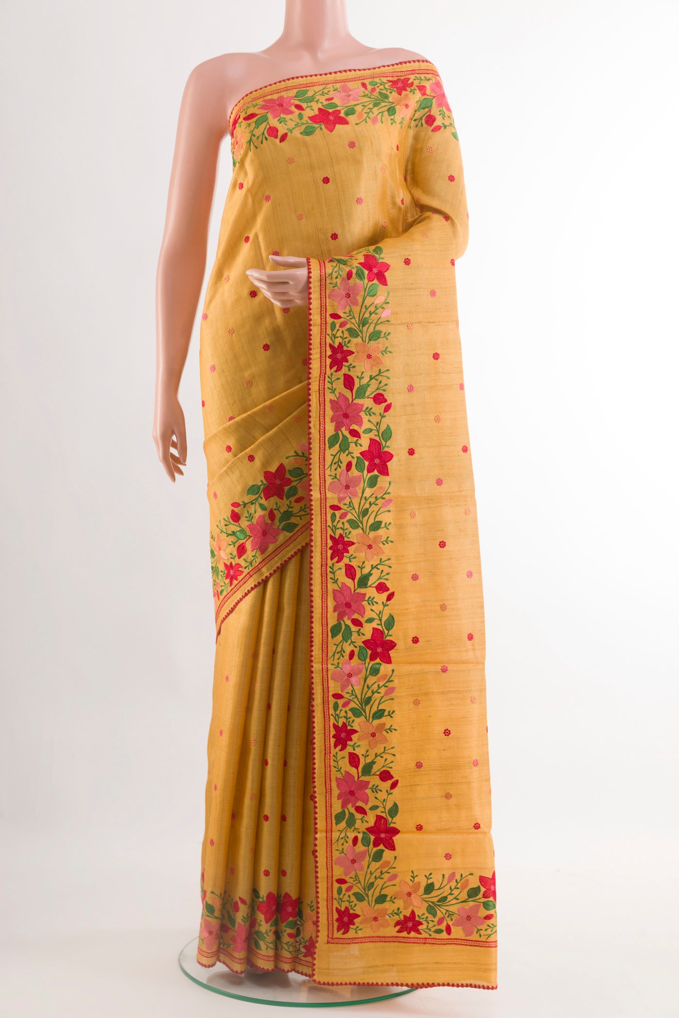 Yellow Tussar Saree with Thread Butta on the body and Zari Border.  displayed on a mannequin