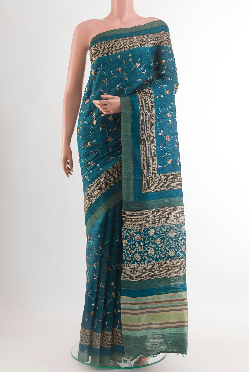 Blue Tussar Saree with Embroidery on the body and Embroidery Border.  displayed on a mannequin