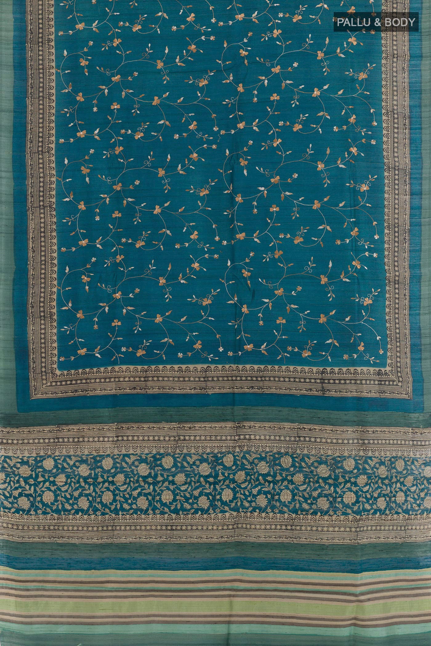 Flat view of Blue Tussar Saree with Embroidery on the body and Embroidery Border. 