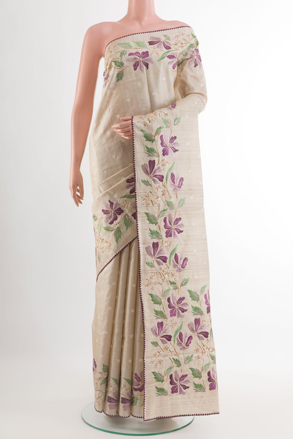 Cream Tussar Saree with Thread Butta on the body and Embroidery Border.  displayed on a mannequin
