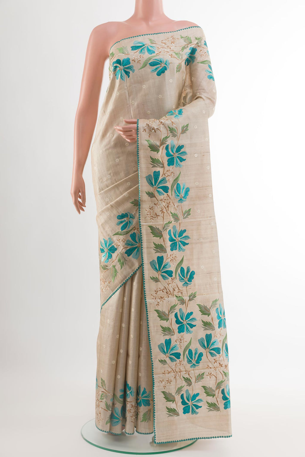 Cream Tussar Saree with Thread Butta on the body and Embroidery Border.  displayed on a mannequin