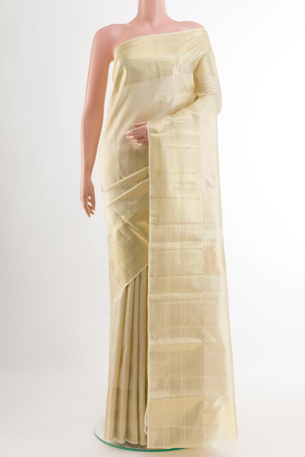 Off White Kanchipuram Silk Saree with Zari Brocade on the body and Zari Border.  displayed on a mannequin