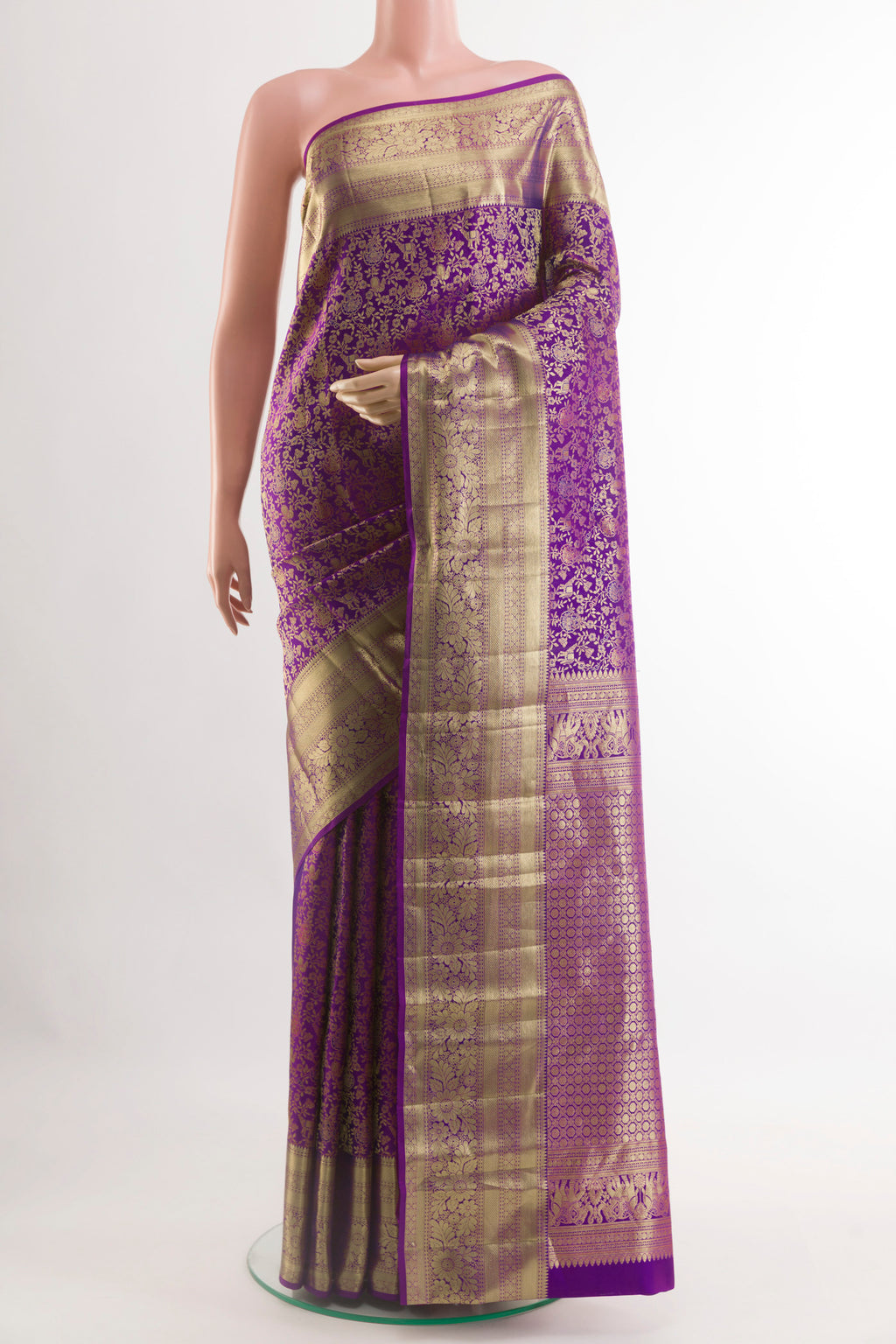 Purple Kanchipuram Silk Saree with Zari Brocade on the body and Zari Border.  displayed on a mannequin