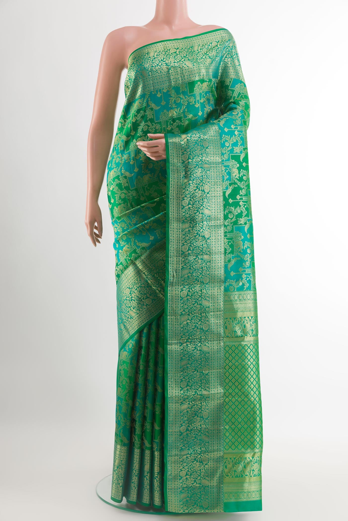 Green Kanchipuram Silk Saree with Zari Brocade on the body and Zari Border.  displayed on a mannequin